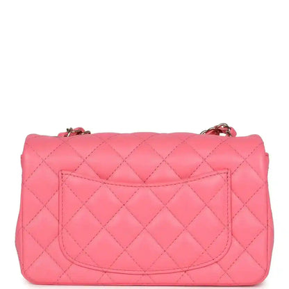 Hot pink quilted mini flap bag with top flap and gold-tone chain attachment