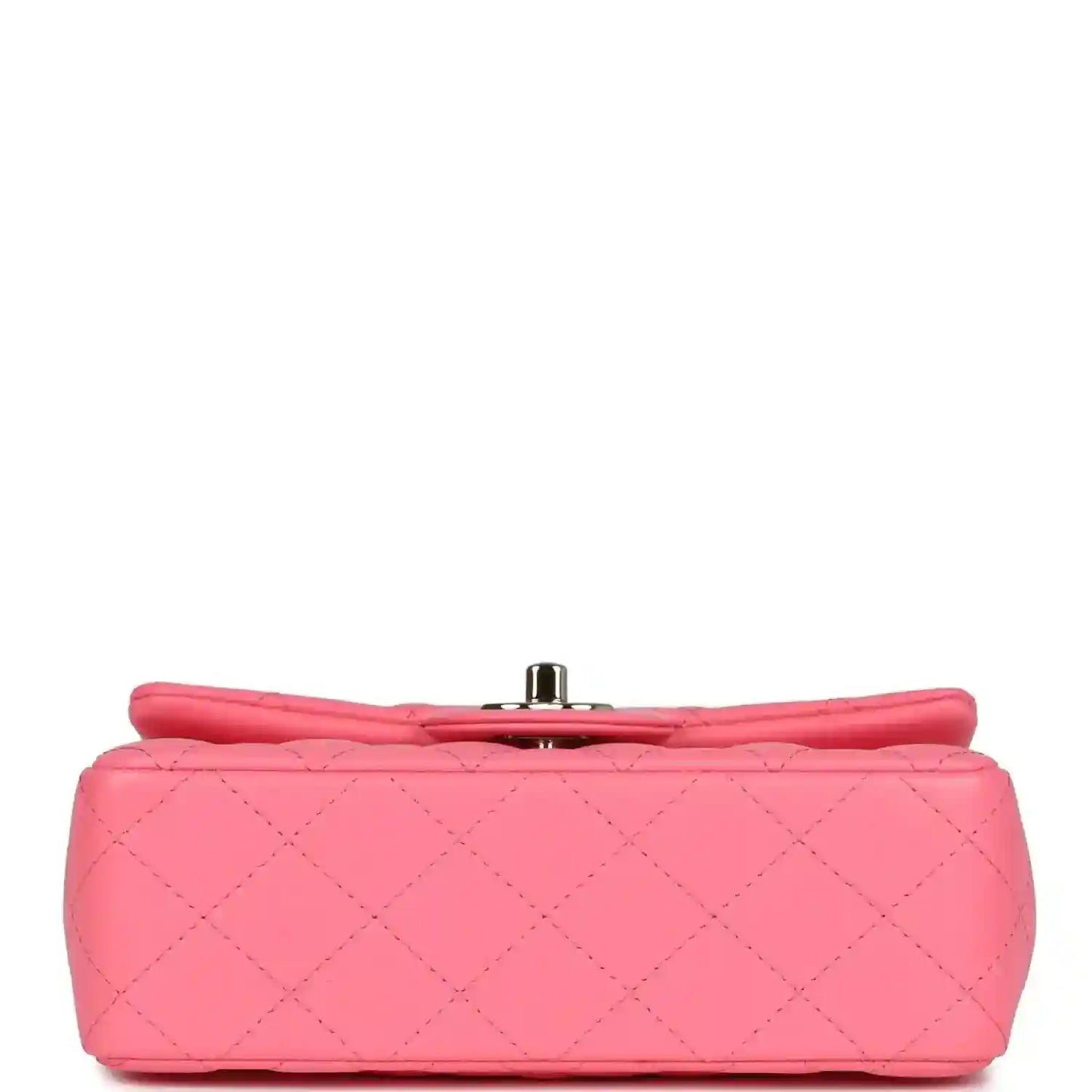 Hot pink quilted mini flap bag with metal turn-lock clasp on base