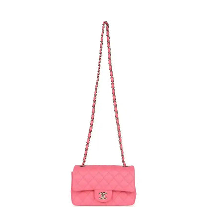 Hot pink quilted mini flap bag with long chain strap and front logo emblem