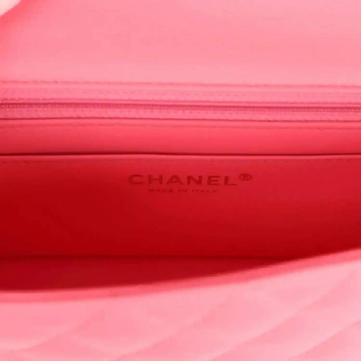 Red interior lining of mini flap bag with embossed CHANEL