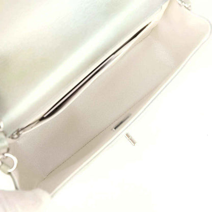 Mini flap bag interior view showing zipper pocket and light leather lining