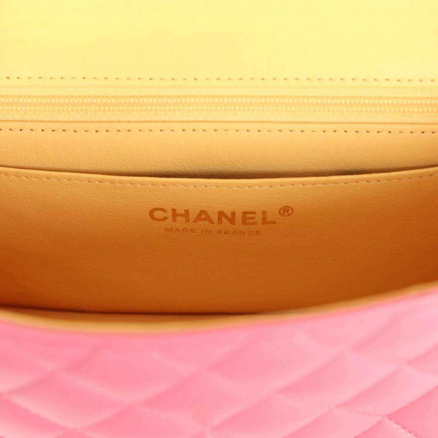 Mini flap bag interior panel with Chanel logo branding and stitched seam