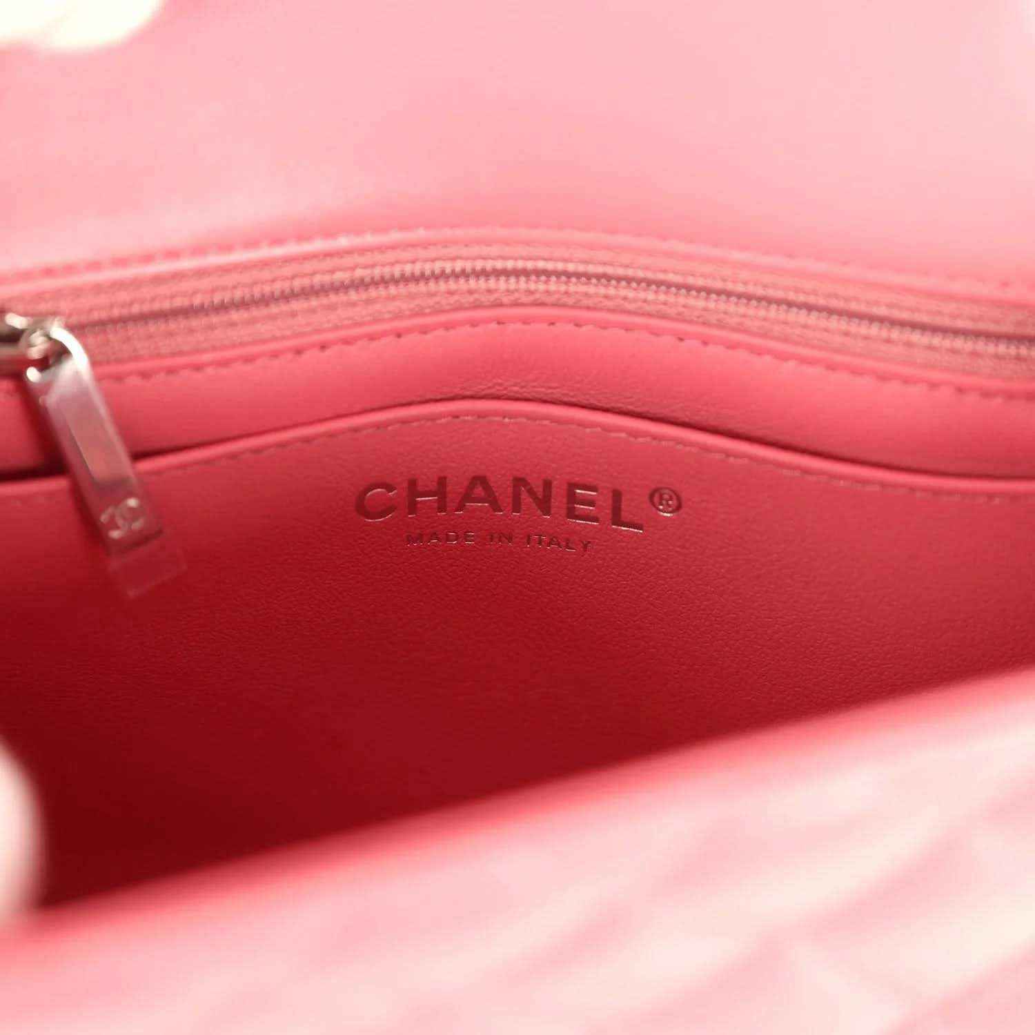 Pink leather-lined interior of Chanel mini flap bag with CHANEL logo stamp