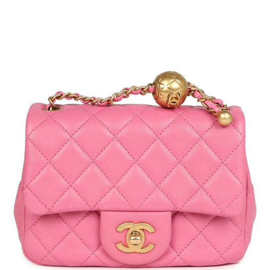Pink quilted mini square flap bag with gold-tone turn-lock and chain strap.