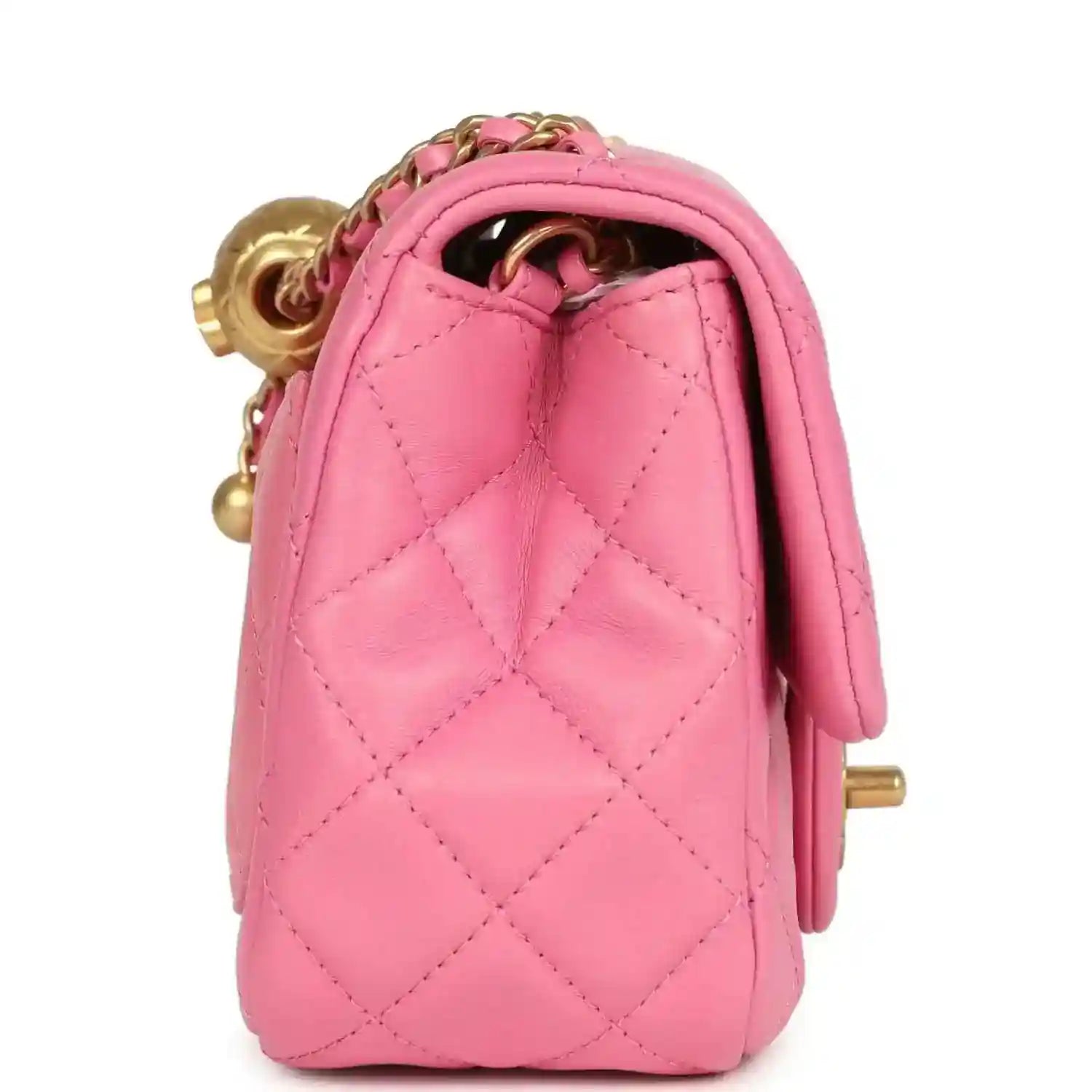 Pink mini flap bag interior opening with gold-tone hardware and chain detail.