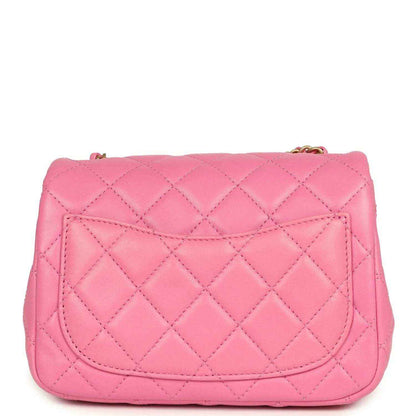 Pink quilted mini square flap bag with gold-tone CC emblem on front flap.