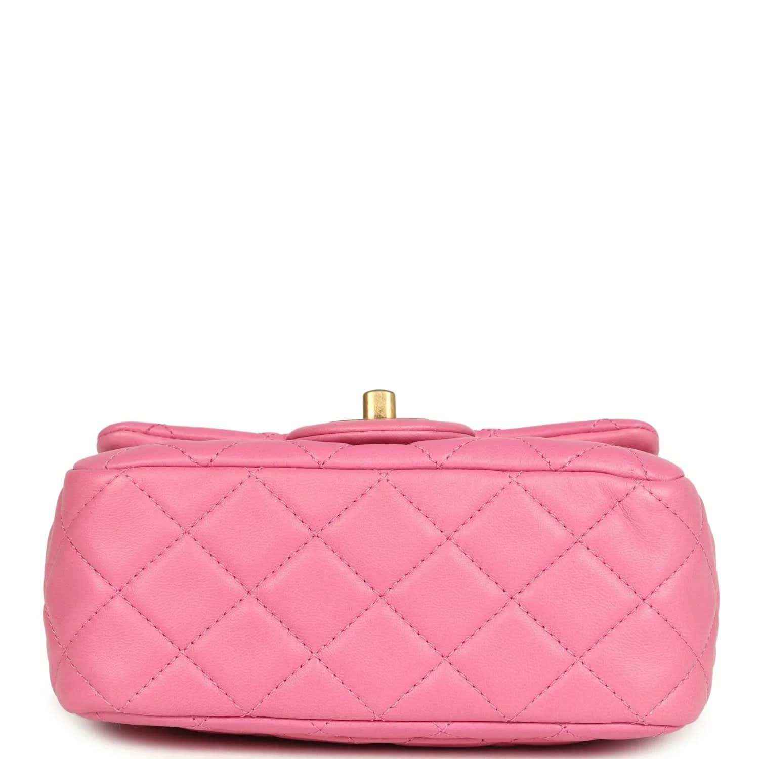 Pink quilted mini bag profile with gold-tone top post and carry handle loop.