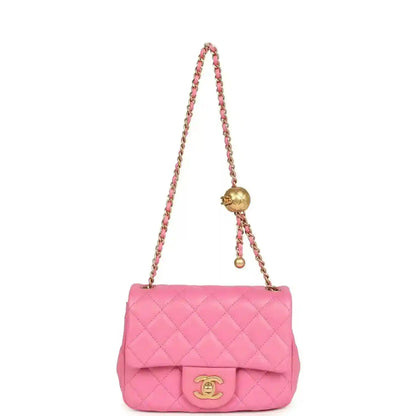 Pink quilted mini shoulder bag with chain strap and gold-tone CC turn-lock.