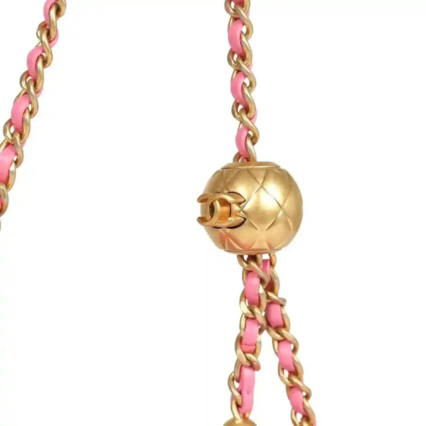 Gold-tone ball clasp on pink chain strap for a quilted mini flap bag.