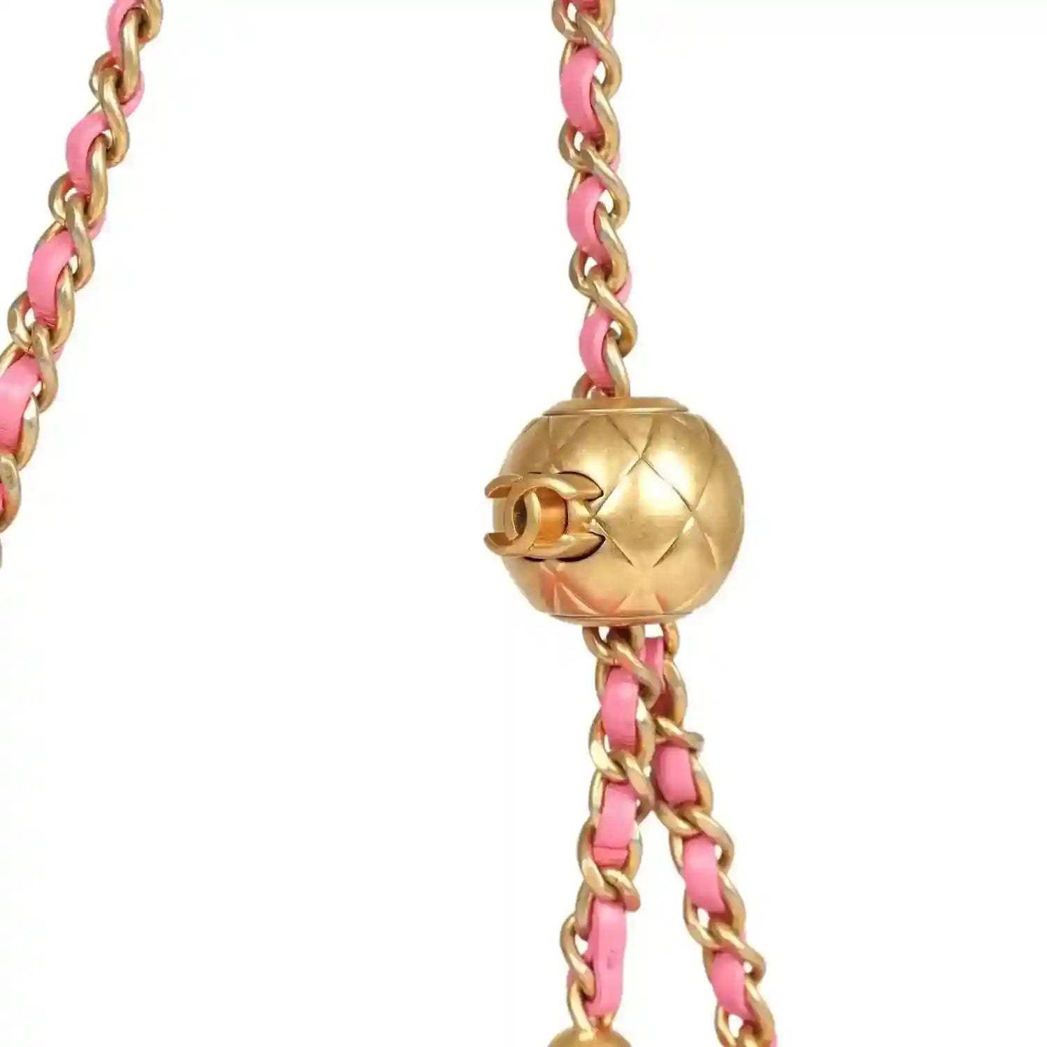 Gold-tone ball clasp on pink chain strap for a quilted mini flap bag.
