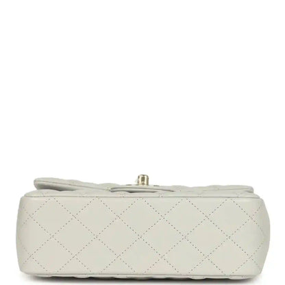 Chanel mini flap bag base view, quilted light leather with small hardware at top