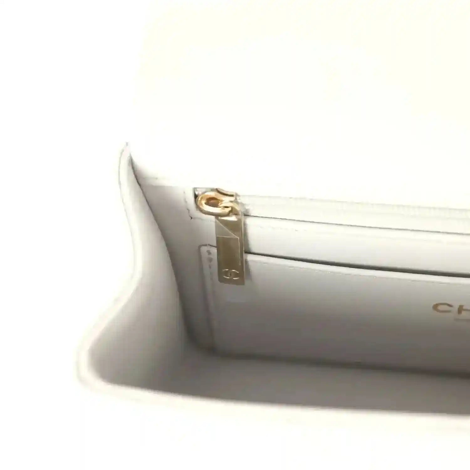 Chanel mini flap bag interior clasp hardware, gold-tone latch detail