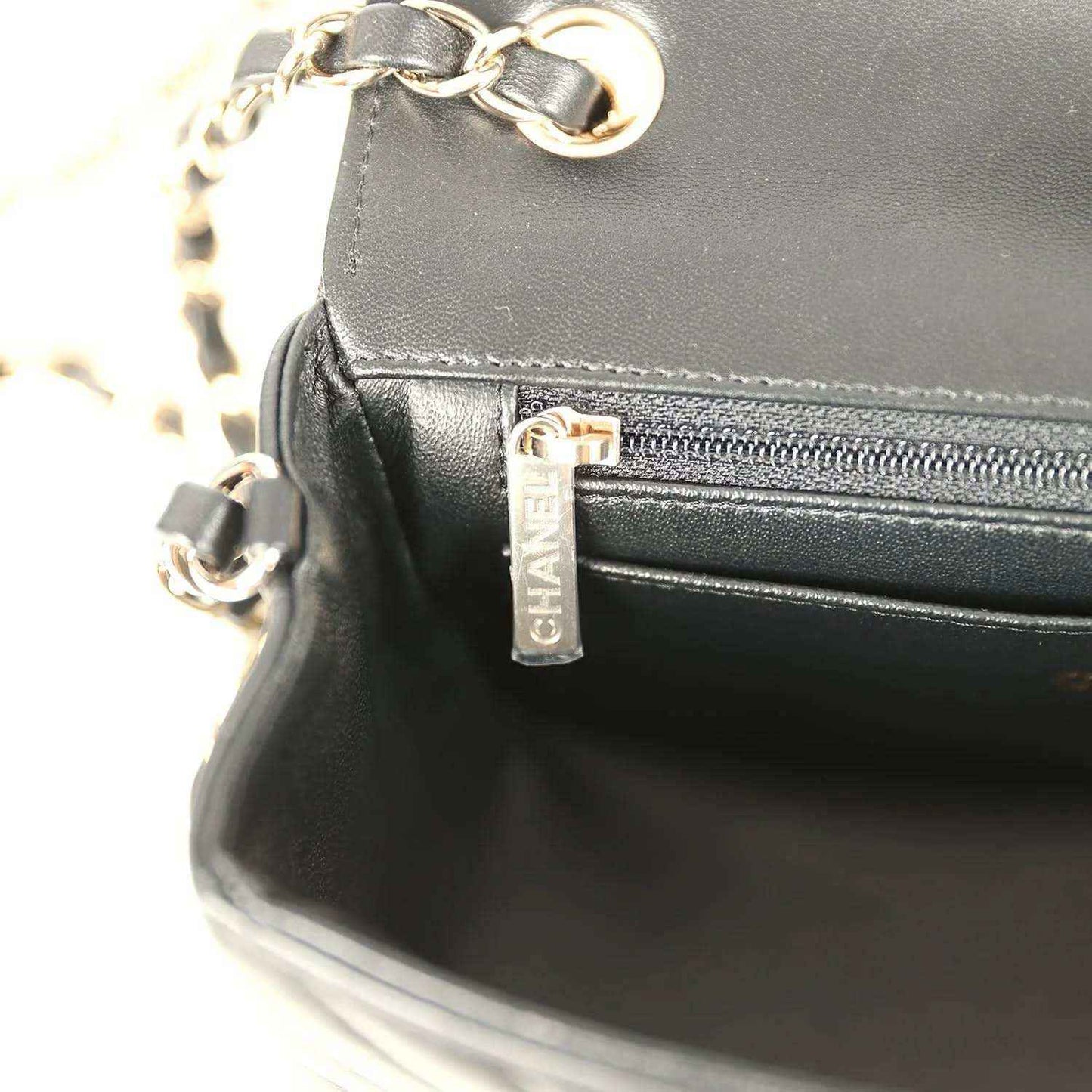 Chanel mini bag zip pocket with logo tag and gold-toned pull