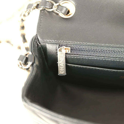 Chanel mini bag zip pocket with logo tag and gold-toned pull