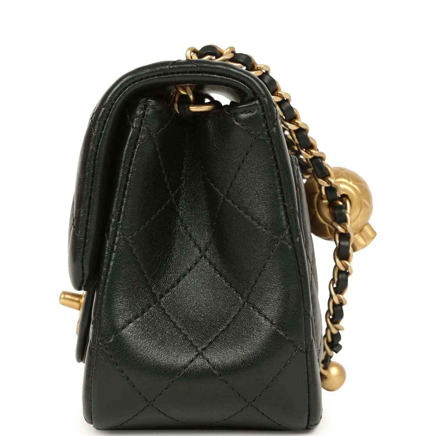 Black mini flap bag side view with quilted leather and gold chain