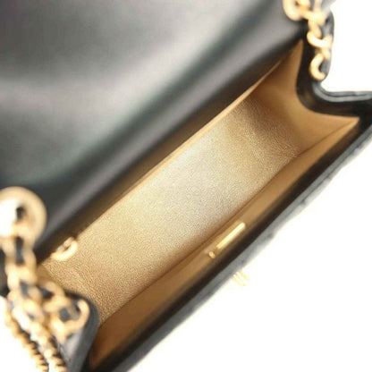 Mini flap bag interior with tan lining and gold hardware edge