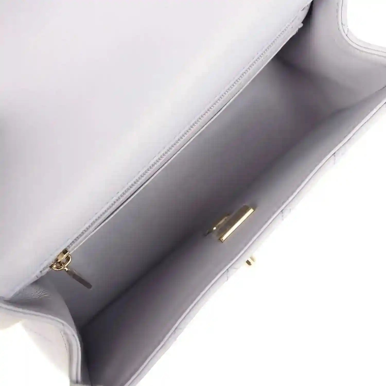 Mini rectangular flap bag interior view with light purple lining and gold zipper hardware