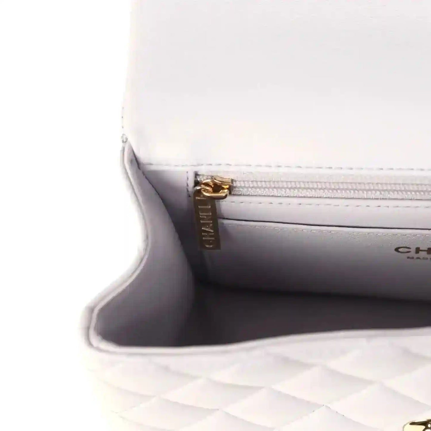Mini rectangular flap bag interior pocket with gold zipper pull and CHANEL branding