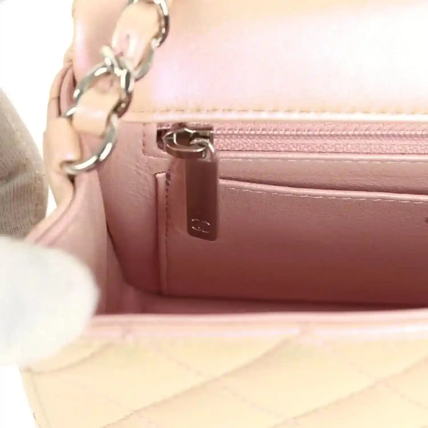 Chanel mini classic flap bag interior zipper pocket with logo pull tab