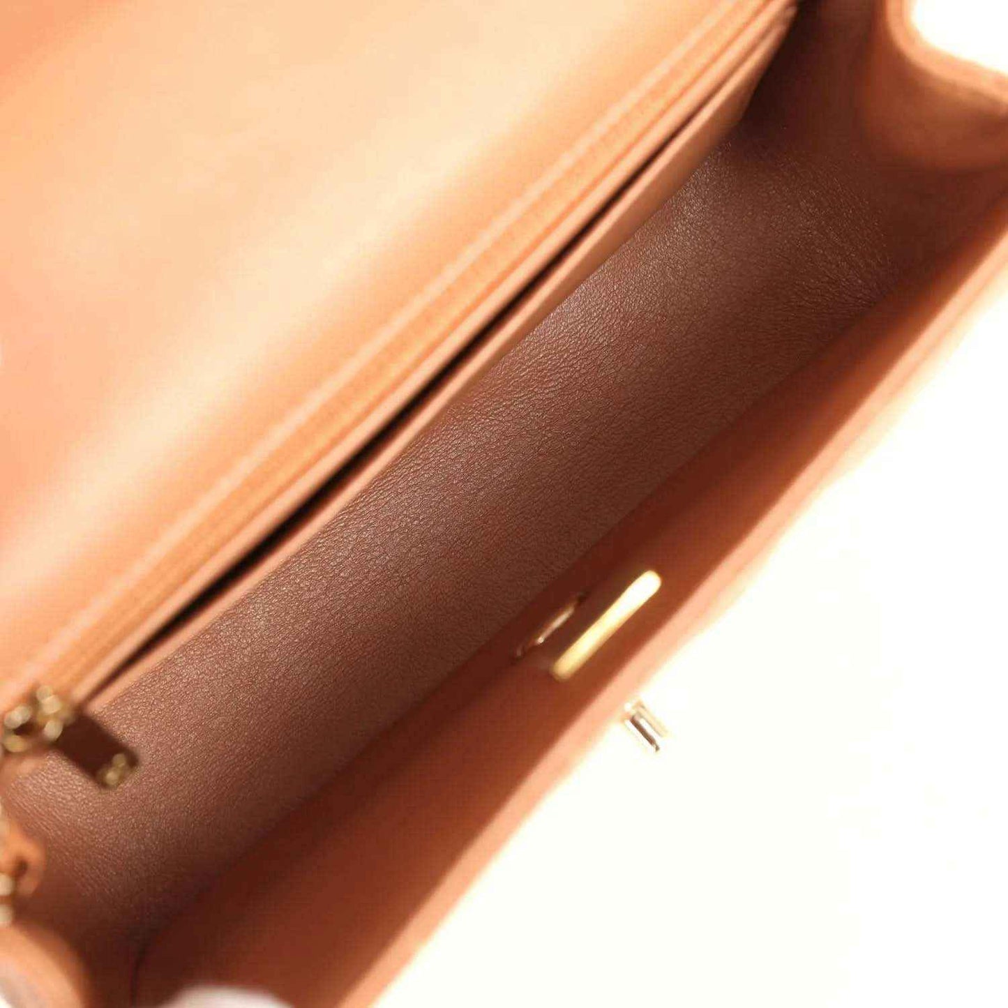 Caramel leather interior close-up with stitched edge and gold-tone zipper trim