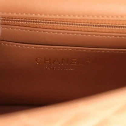 Caramel leather interior pocket with stamped CHANEL and stitched zipper seam