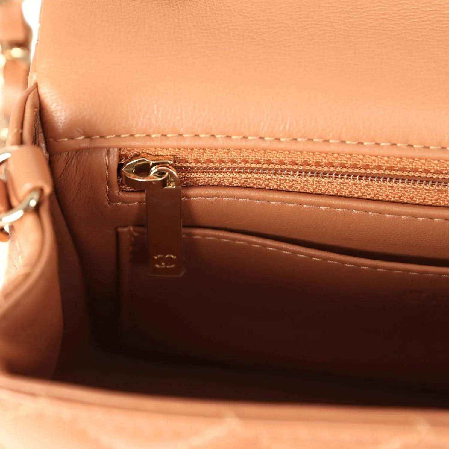 Caramel interior pocket with gold-tone zipper and CHANEL logo pull tab