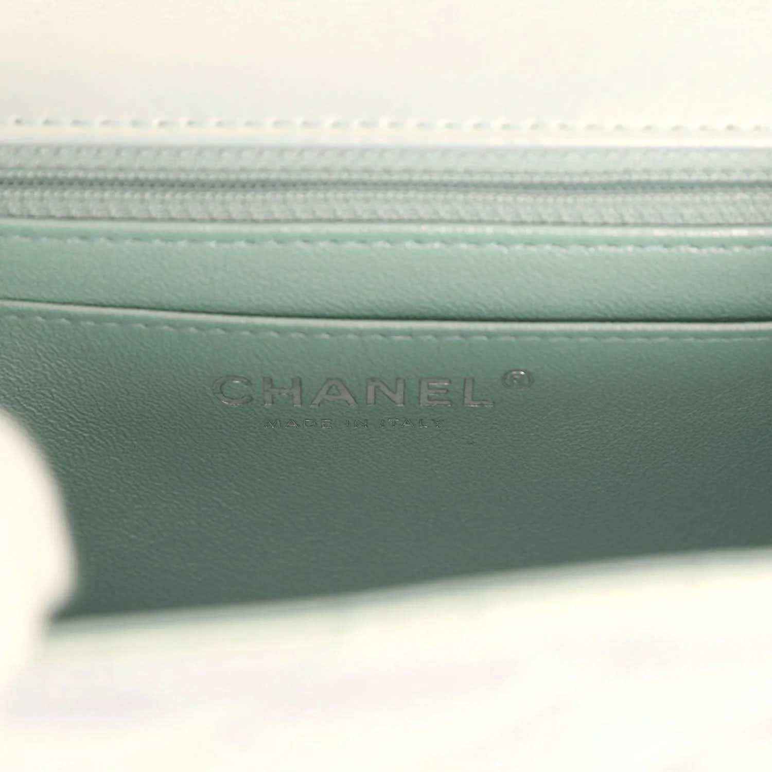 Mini square flap bag interior with embossed CHANEL branding on light blue leather lining