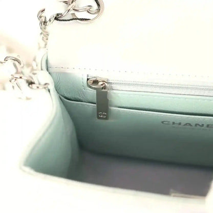 Mini square flap bag interior pocket with zipper and CHANEL logo on light blue leather lining