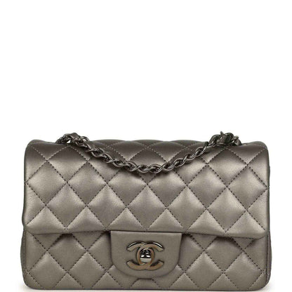 Quilted silver mini flap bag with chain strap and Chanel CC logo on front