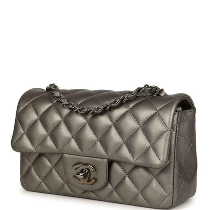 Silver quilted flap bag with chain strap and Chanel CC logo on front flap