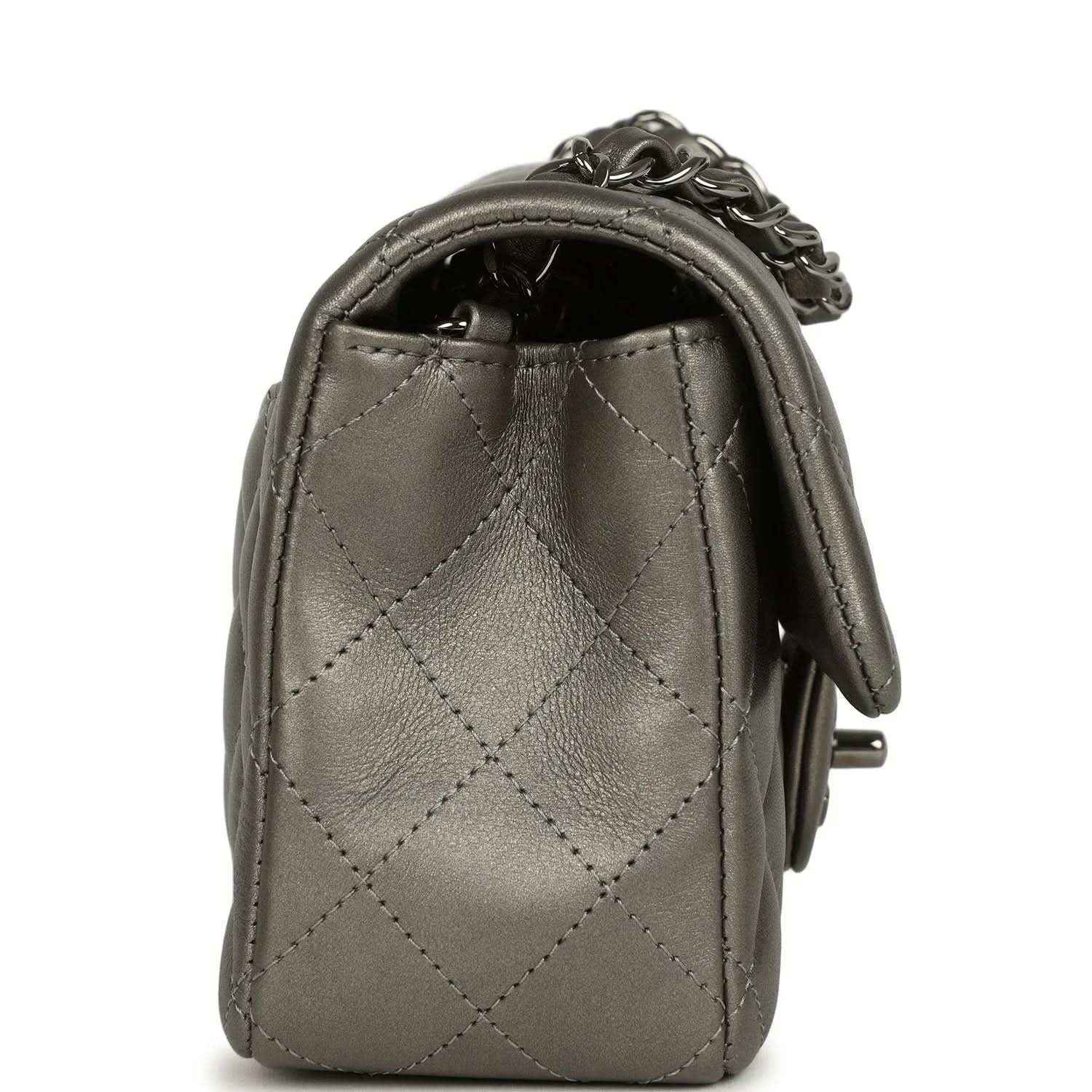 Silver quilted flap bag side view with chain strap and stitched diamond pattern