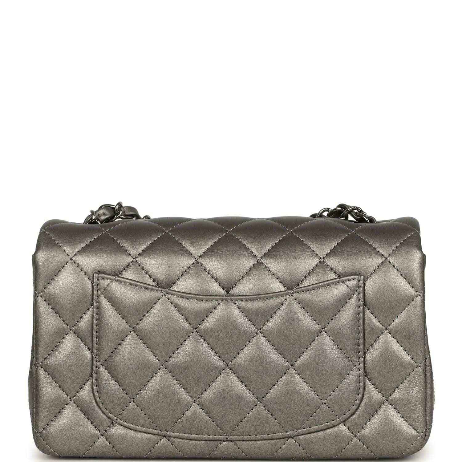 Silver quilted mini flap bag back with recessed pocket and chain hardware