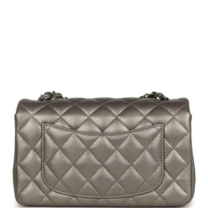 Silver quilted mini flap bag back with recessed pocket and chain hardware