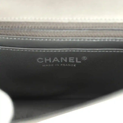 Bag interior label reading CHANEL and MADE IN FRANCE on black lining