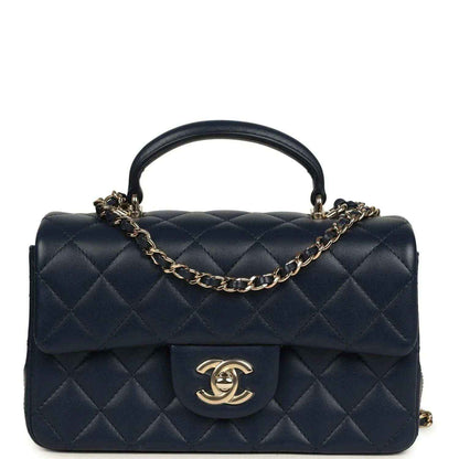 Navy quilted lambskin flap top handle bag with gold-tone chain and CC logo