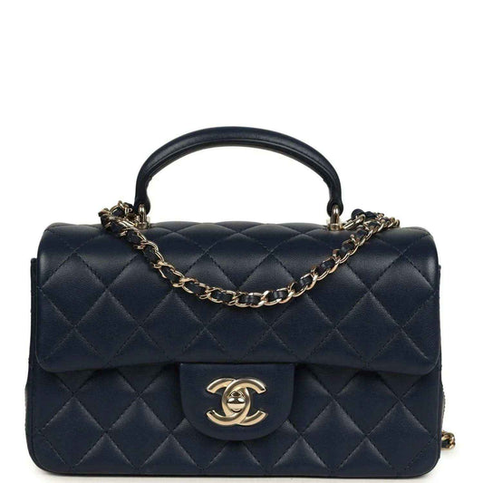 Navy quilted lambskin flap top handle bag with gold-tone chain and CC logo