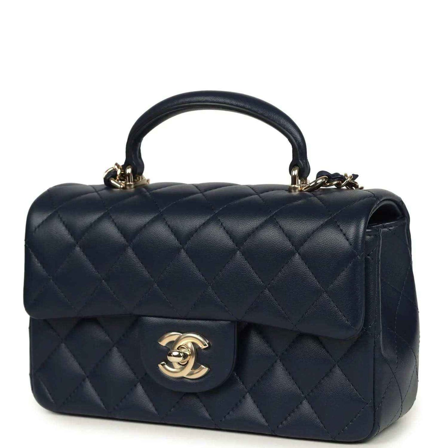 Navy quilted flap top handle bag with gold-tone CC logo and chain shoulder strap