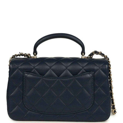 Navy quilted lambskin flap bag with gold-tone CC logo and front pocket panel