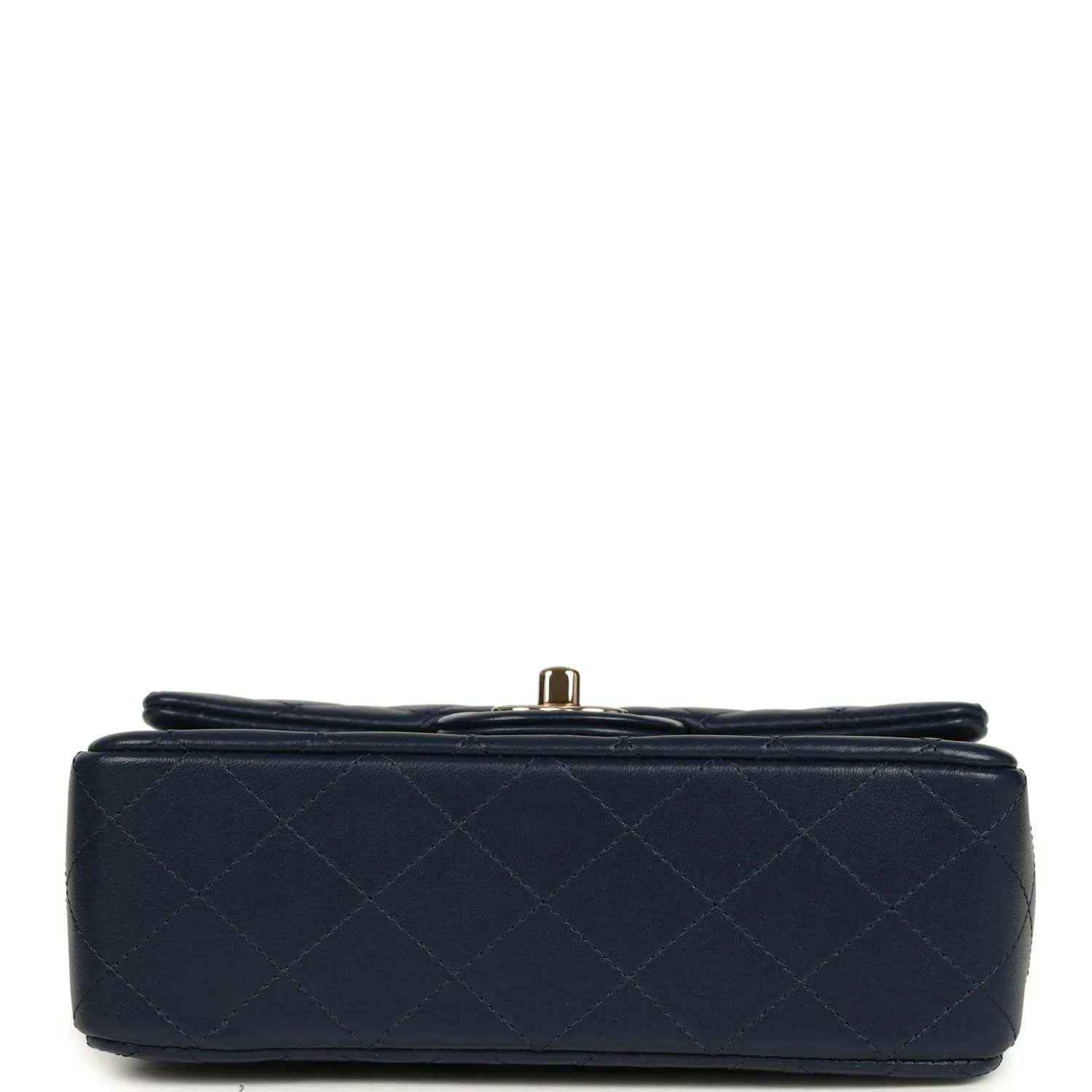 Navy quilted mini flap bag base with small gold-tone hardware knob