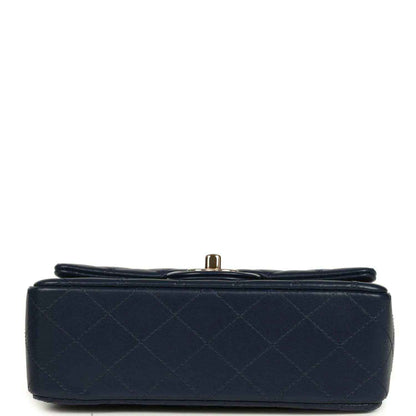 Navy quilted mini flap bag base with small gold-tone hardware knob