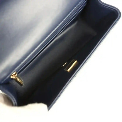 Navy leather interior of quilted mini flap bag with gold-tone clasp