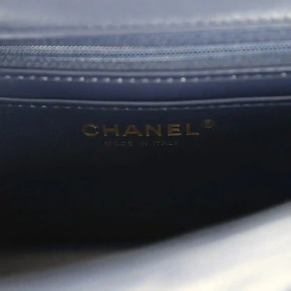 Dark navy leather bag lining with CHANEL logo debossed near zipper