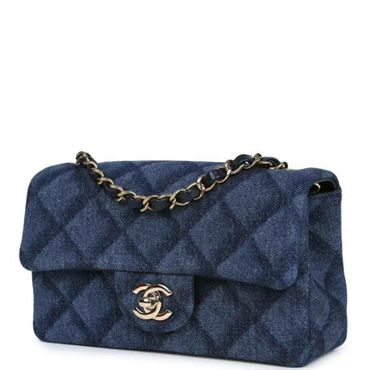 Chanel mini flap bag, angled view, blue denim with gold chain strap and logo clasp