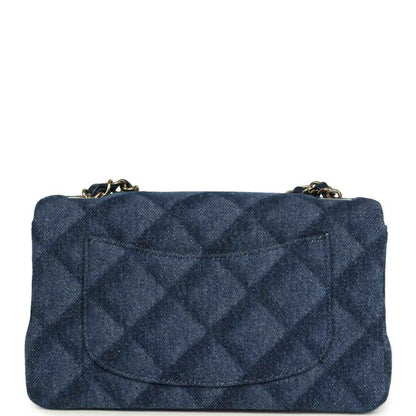 Chanel mini flap bag, front view, blue denim quilted design and gold logo clasp