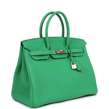 Green leather Birkin-style top-handle handbag with front flap lock and key charm