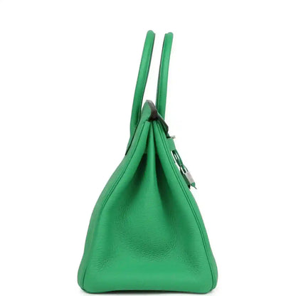 Green leather top-handle handbag with gathered sides and hanging lock charm