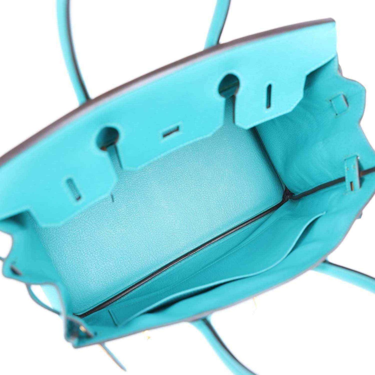Blue peacock leather lining with open front, bar accents, and inner compartment edge