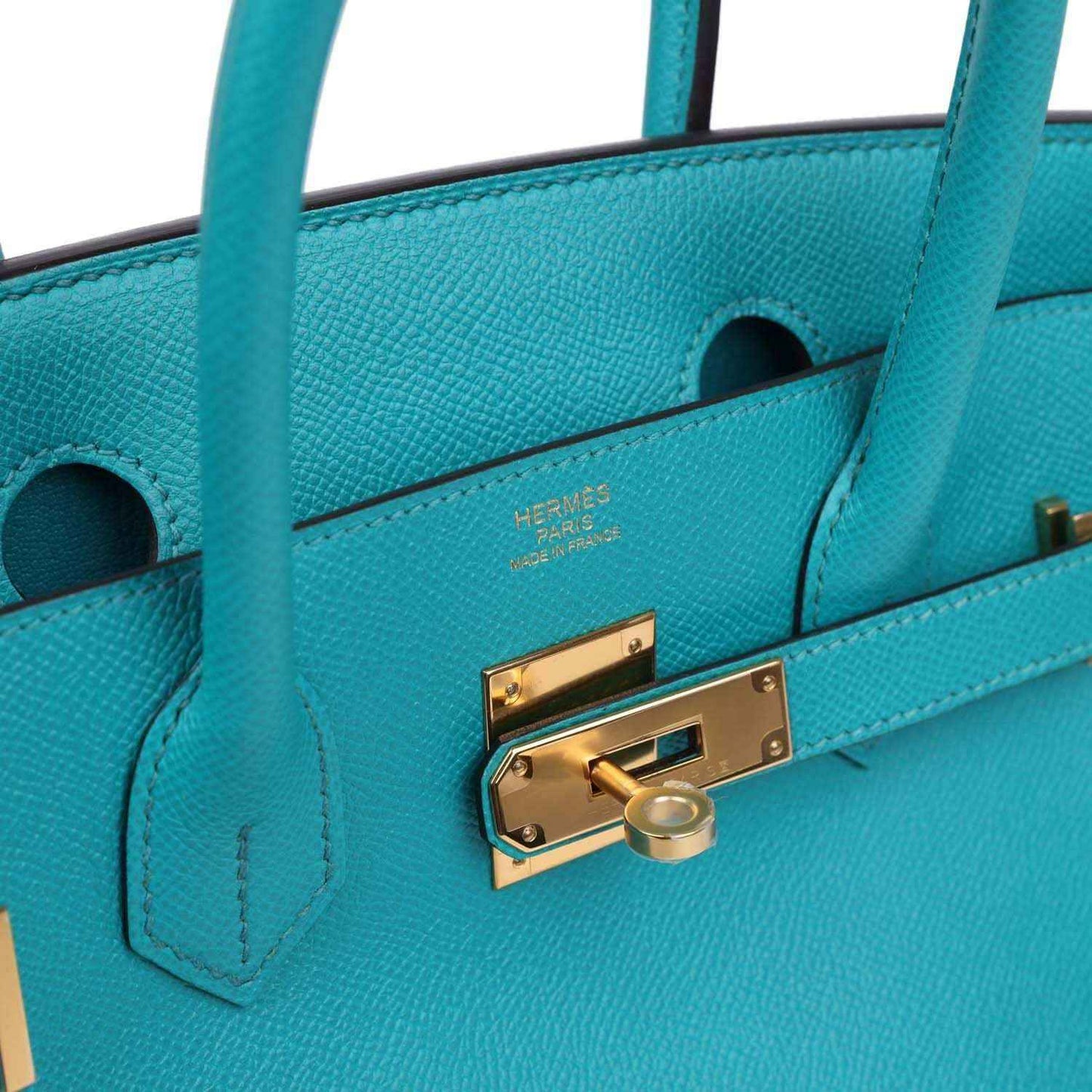 Blue peacock leather interior pocket with gold clasp hardware and stitched logo detail