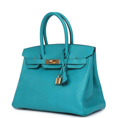 Blue peacock leather handbag with gold lock clasp, top handles, and side panels