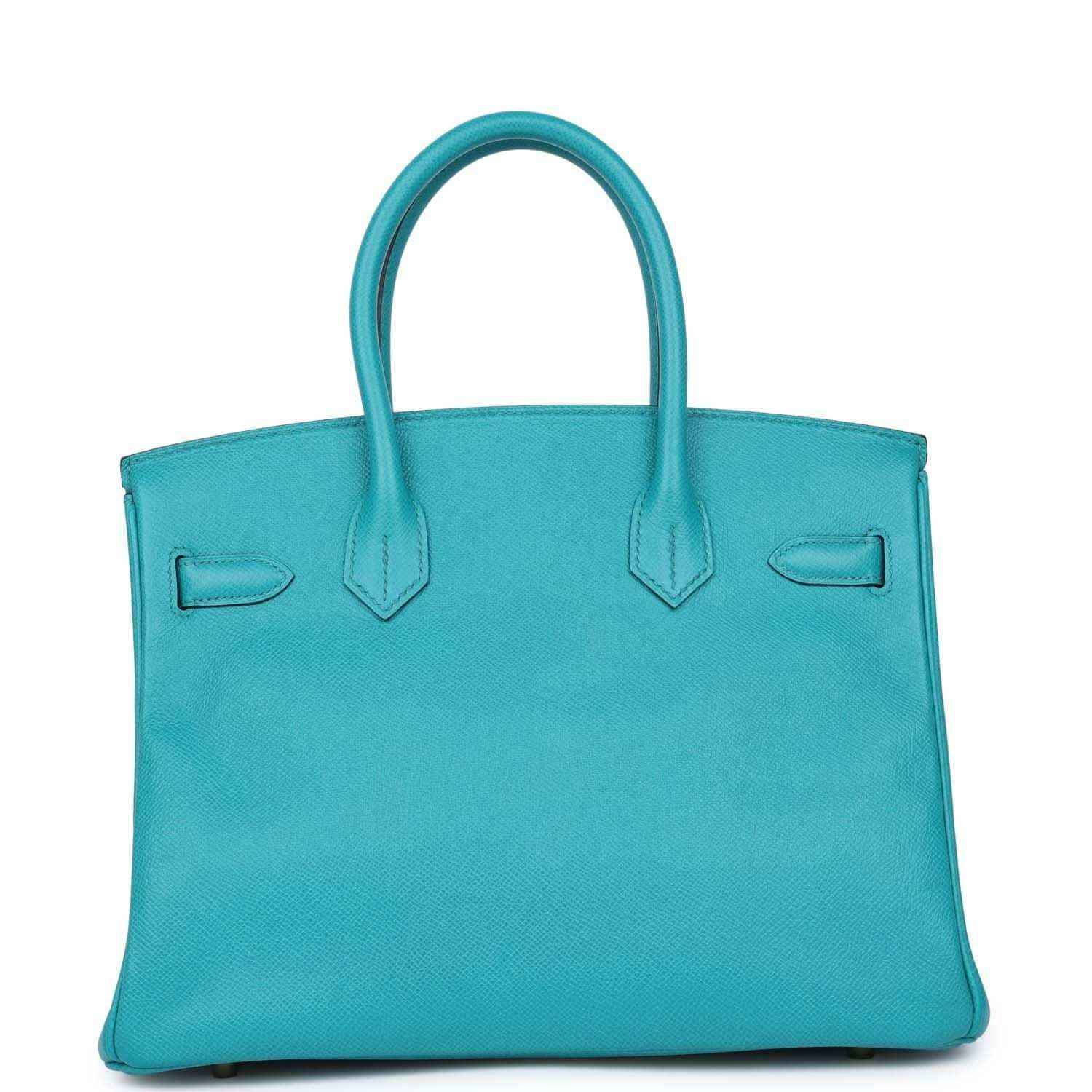 Blue peacock leather tote bag with top handles and front flap detail